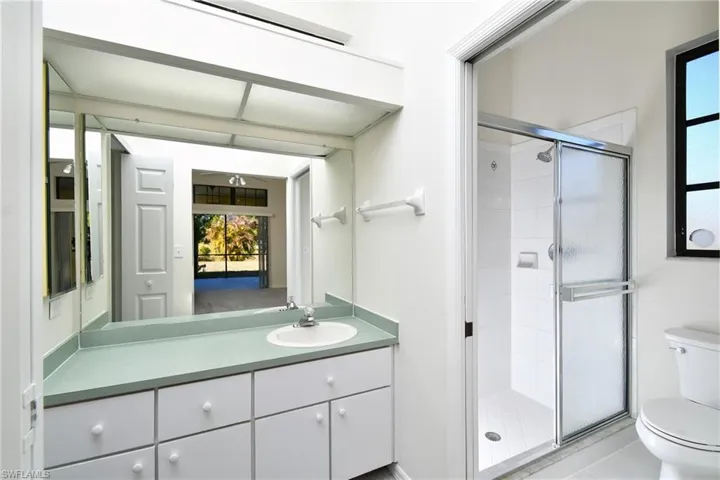 Full bath featuring a shower stall, vanity, and tile patterned floors