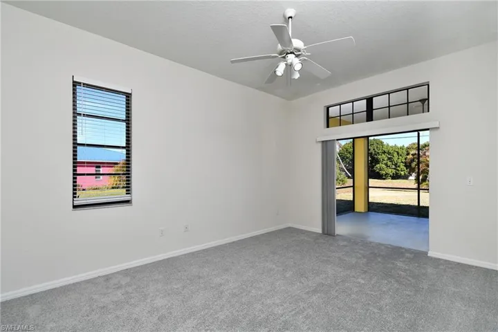 Spare room with carpet, ceiling fan, and a textured ceiling
