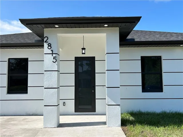 Property entrance with roof with shingles