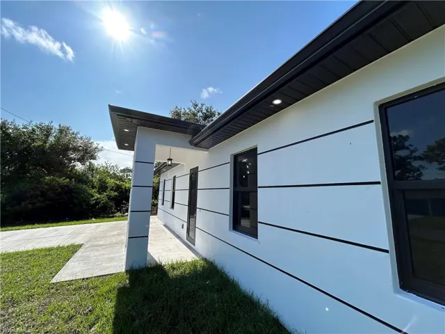 View of side of property featuring a yard