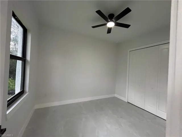 Unfurnished bedroom featuring a closet and ceiling fan