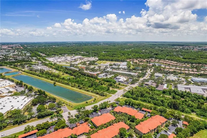 Expansive aerial perspective showcasing lush, mature landscaping and multiple bodies of water