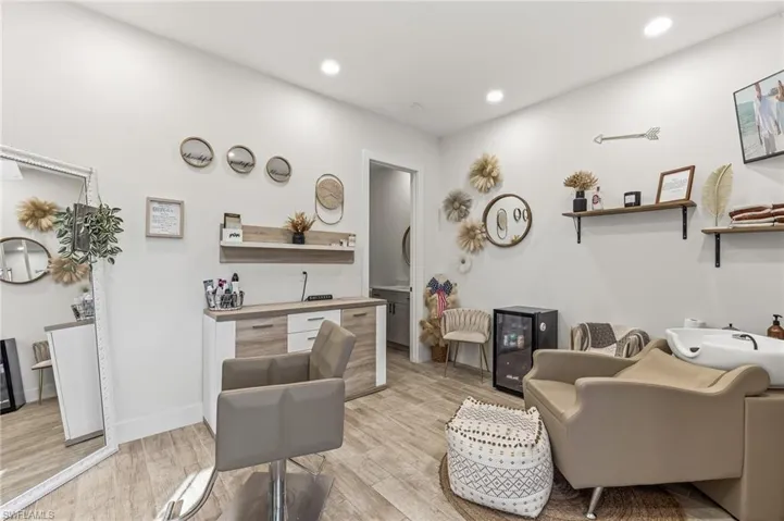 Living area with light wood finished floors, recessed lighting, and wine cooler