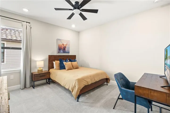 Bedroom featuring baseboards, recessed lighting, and light colored carpet