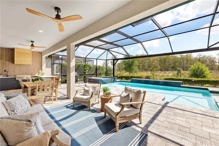 View of pool with a patio, outdoor dining space, a pool with connected hot tub, and outdoor lounge area