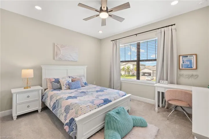 Bedroom featuring baseboards, ceiling fan, recessed lighting, and light colored carpet