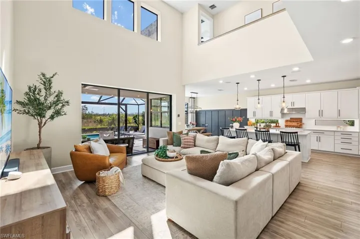 Living area featuring light wood-style flooring, visible vents, a sunroom, and recessed lighting