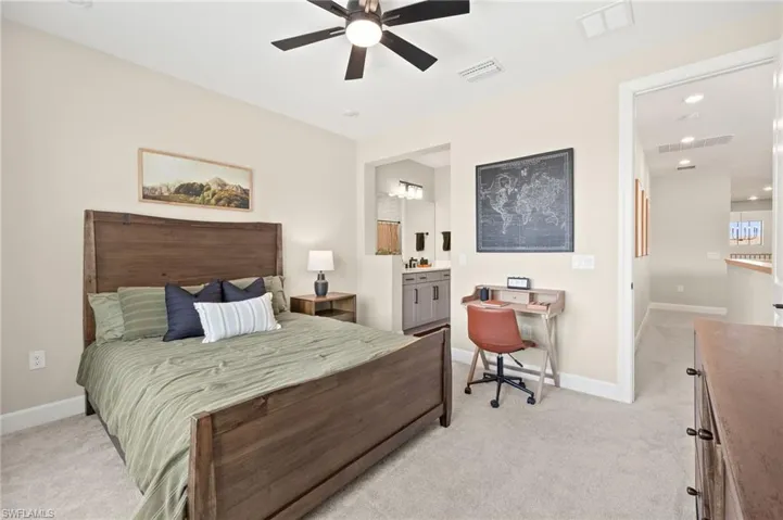 Bedroom featuring baseboards, light colored carpet, and visible vents