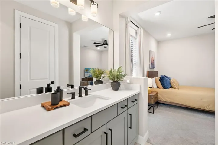 Bathroom featuring ensuite bath, ceiling fan, recessed lighting, and vanity