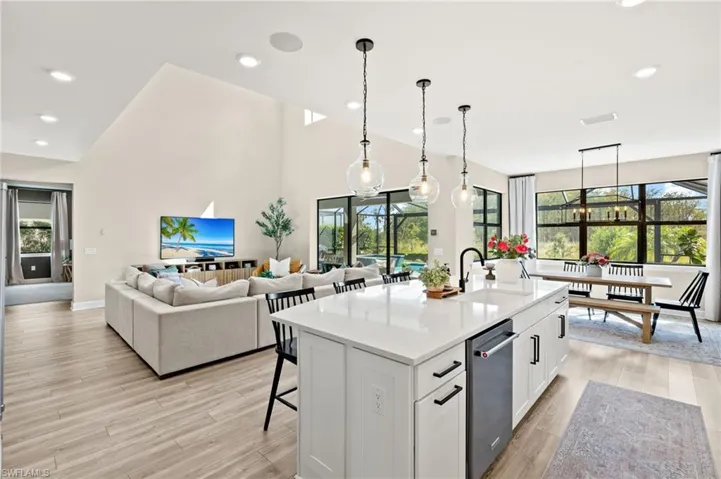 Kitchen featuring white cabinetry, light countertops, a sink, and light wood-style floors