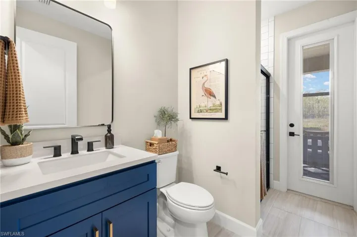 Full bathroom featuring baseboards, toilet, and vanity