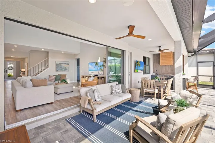 Living area with stairs, recessed lighting, and a ceiling fan
