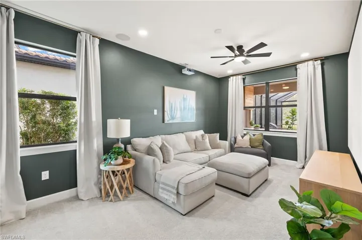 Living room featuring a ceiling fan, carpet floors, baseboards, and recessed lighting