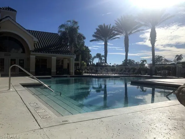 Community pool with a patio