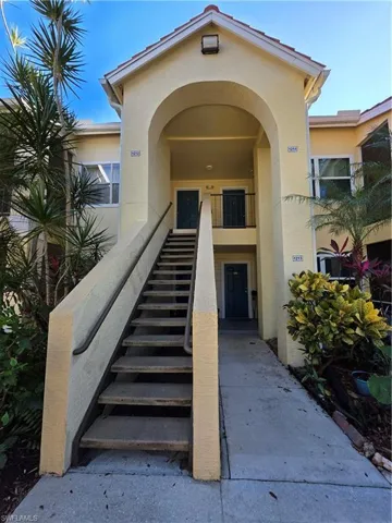 Property entrance featuring stucco siding
