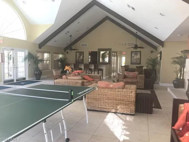 Recreation room featuring vaulted ceiling and french doors