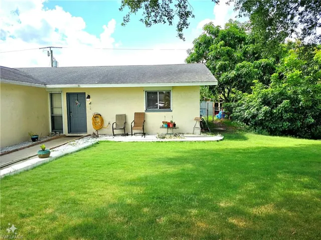 Back of house with a lawn