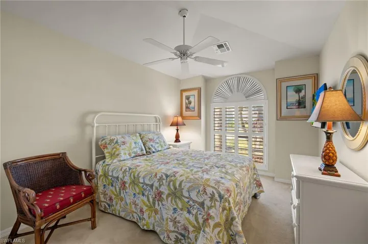 Bedroom with light colored carpet and ceiling fan