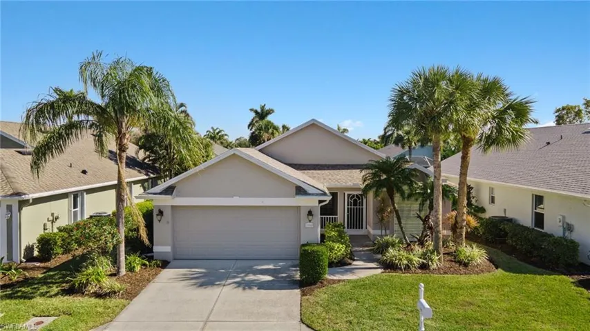 View of front of property with a front yard and a garage
