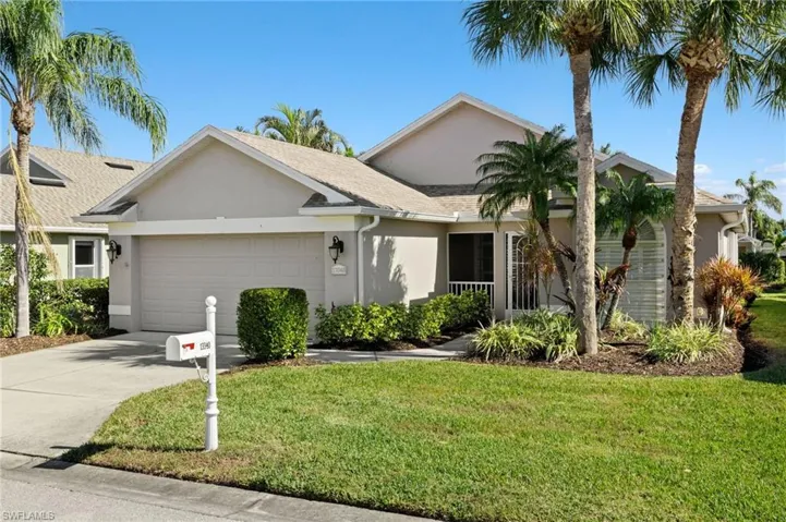 Ranch-style house featuring a front lawn and a garage