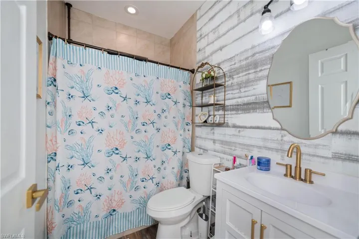 Full bathroom featuring vanity and a shower with shower curtain