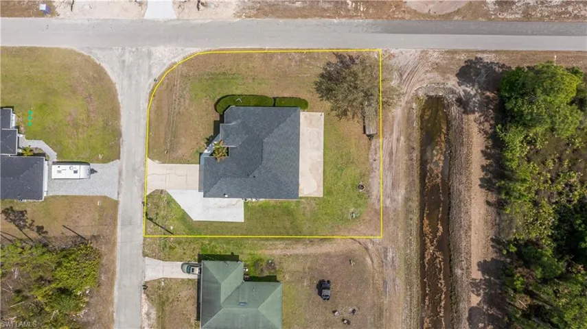 Aerial view of property and surrounding area with property parcel outlined