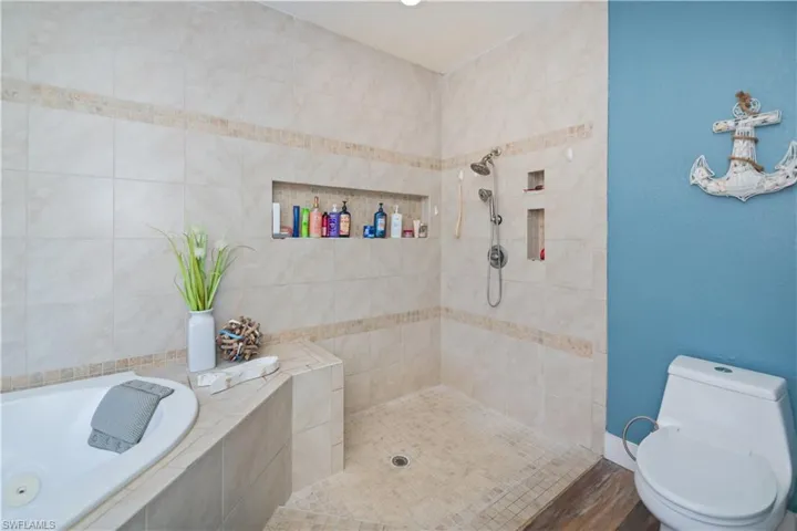 Bathroom with walk in shower and a garden tub