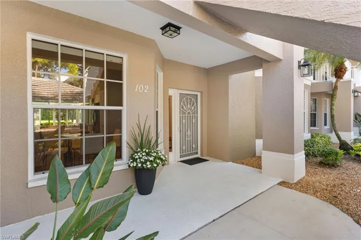 Property entrance with stucco siding and covered porch