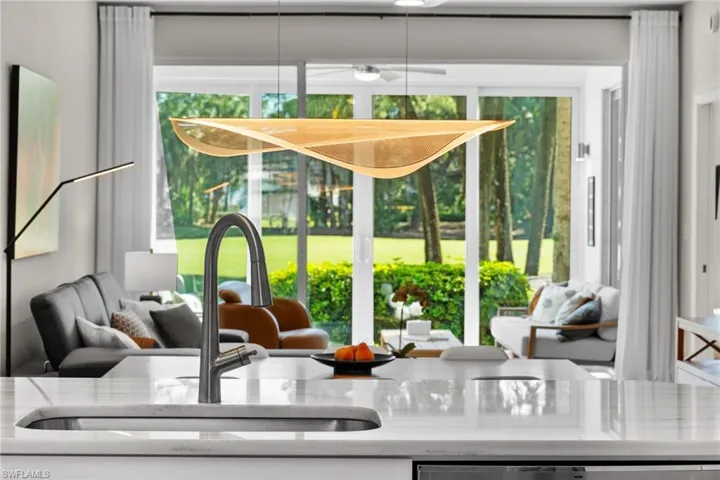 Kitchen view of a sink and light stone countertops
