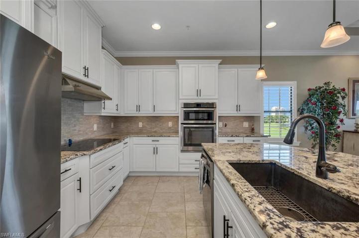 Deep stainless steel sink and granite countertops.