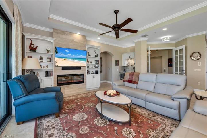 Living Room with custom built shelving and electric fireplace.