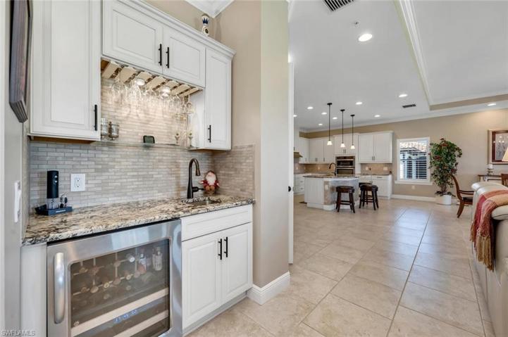 Wet Bar features custom backsplash and wine chiller.