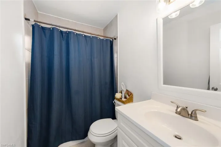 Bathroom with vanity and a shower with shower curtain