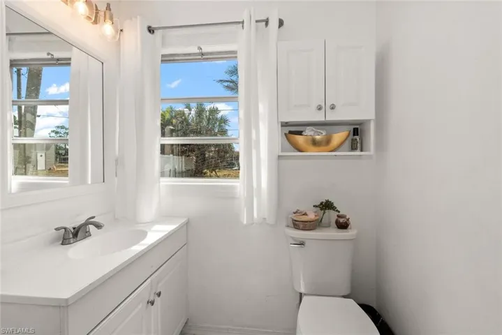 Half bath featuring vanity and healthy amount of natural light