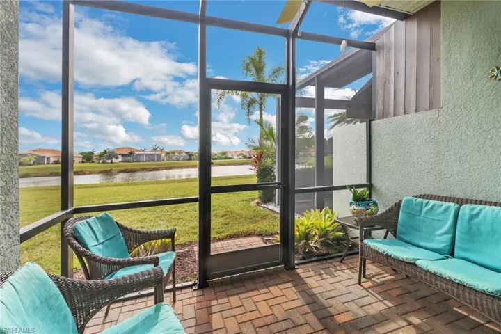 Sunroom / solarium featuring a healthy amount of sunlight and a water view