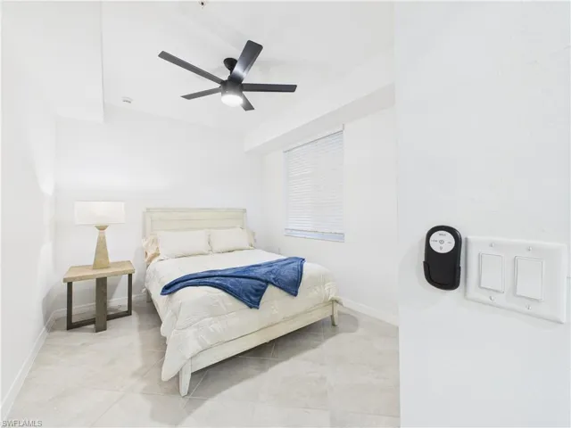 Bedroom featuring tile patterned floors and a ceiling fan