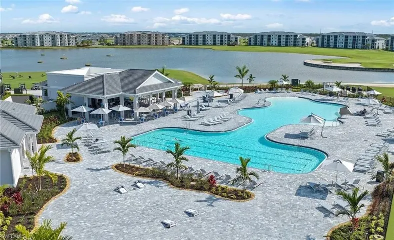 Community pool with a patio area and a water view