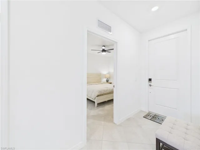 Entryway featuring light tile patterned floors, a ceiling fan, and recessed lighting