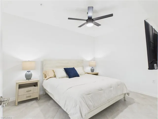 Bedroom featuring light tile patterned flooring and ceiling fan