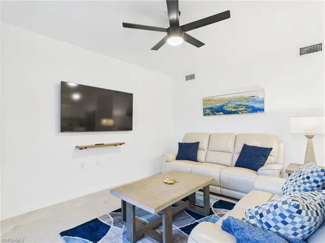 Living room with baseboards and ceiling fan