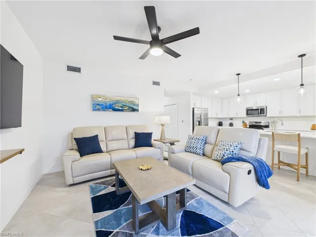 Living area featuring recessed lighting, ceiling fan, and light tile patterned floors