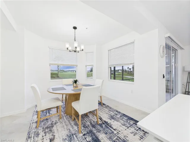 Dining space featuring baseboards and a chandelier