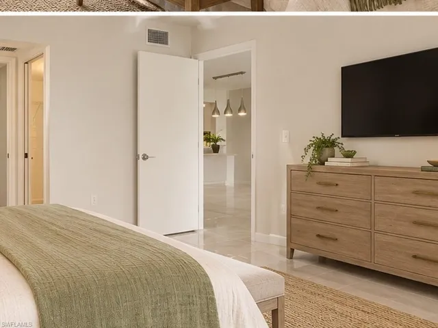 Neutral-toned interior featuring large-format tile flooring, smooth wall finishes, and a door to an interior space with multi-light pendant fixtures