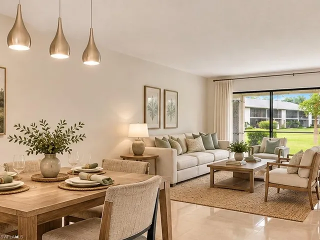 Open-concept space featuring polished tile flooring, three metallic teardrop pendant lights, and a sliding glass door providing natural illumination