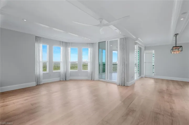 Living room with sleek fan & recessed lighting