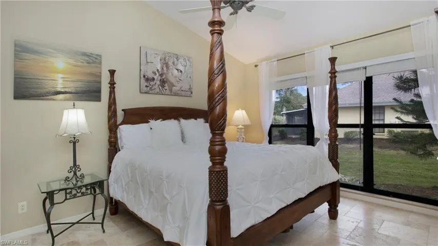 Bedroom with ceiling fan and lofted ceiling