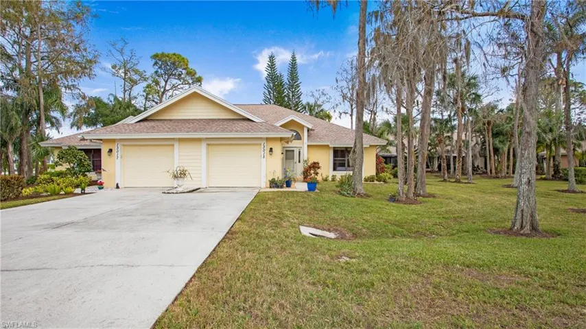 Ranch-style home with a front lawn and a garage