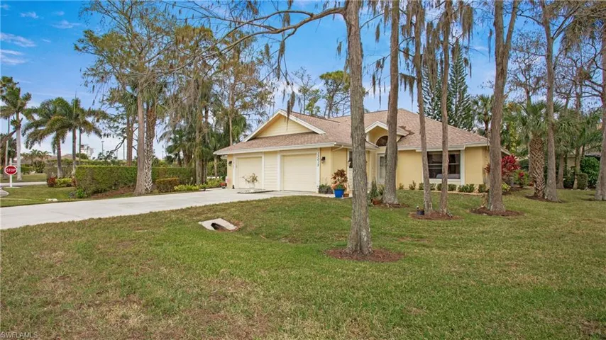 View of front of house with a front lawn and a garage