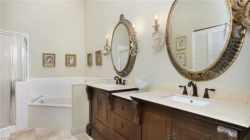 Bathroom featuring separate shower and tub and vanity