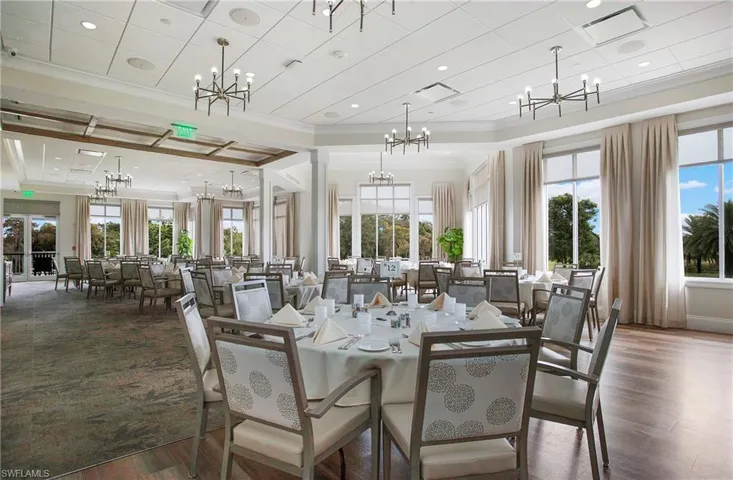 Dining area featuring decorative columns, dark hardwood / wood-style flooring, and ornamental molding